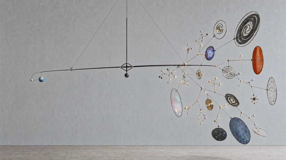 A suspended mobile balances a small Earth against branching stars, planets, and galaxies.